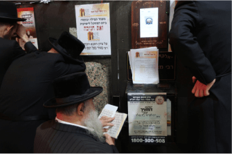 man praying at kever of miracle maker