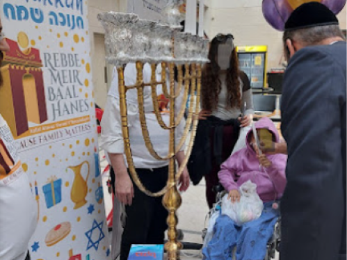 Jewish menorah lighting with Rebbe Meir Baal Haness volunteers